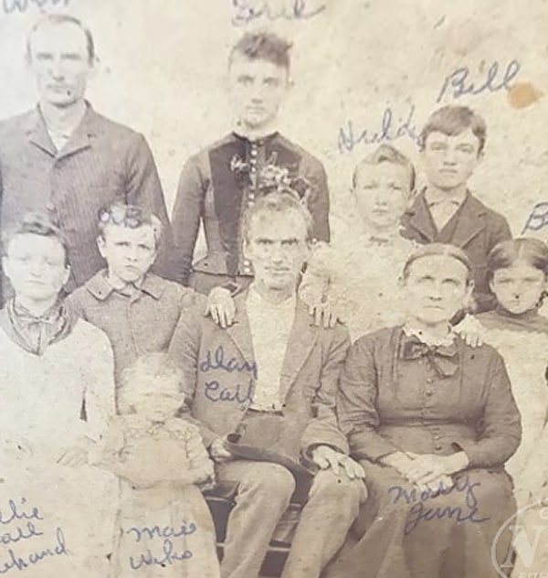 aged and worn photo of Dan Call and family